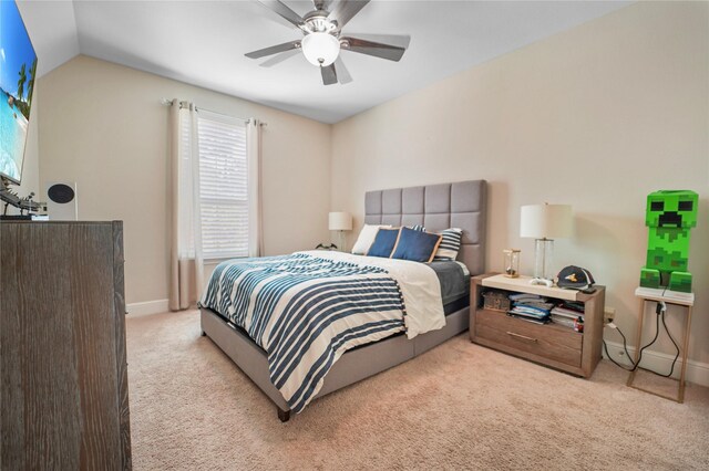 carpeted bedroom with baseboards, a ceiling fan, and lofted ceiling