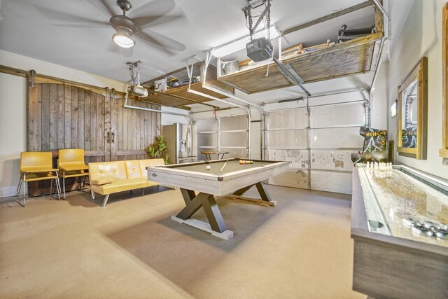 recreation room featuring a garage and a ceiling fan