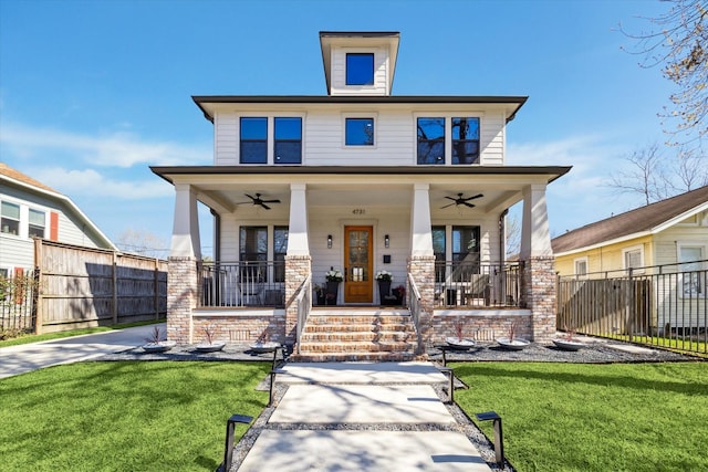 american foursquare style home featuring a ceiling fan and a porch