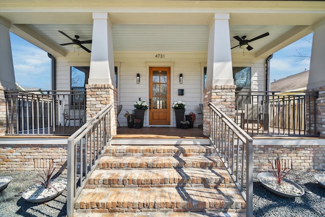 view of exterior entry with a ceiling fan and covered porch