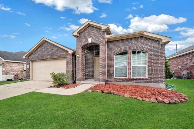 view of front of house featuring brick siding, a front lawn, and a garage
