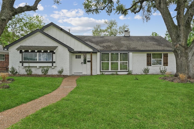 5927 Warm Springs Rd, Houston, TX 77035 - ranch-style home with brick siding, board and batten siding, a front yard, and a chimney