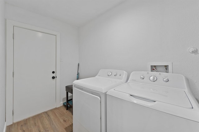 5927 Warm Springs Rd, Houston, TX 77035 - clothes washing area featuring washing machine and clothes dryer and light wood-type flooring