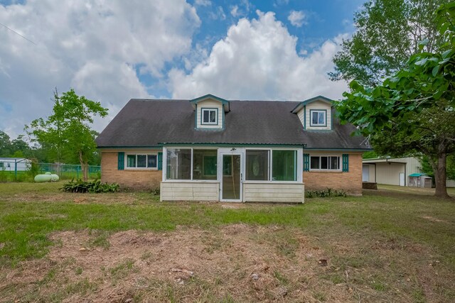 back of house with brick siding and a sunroom