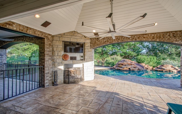 9803 White Rock Lake Trl, Cypress, TX 77433 - view of patio featuring ceiling fan, an outdoor pool, and exterior kitchen