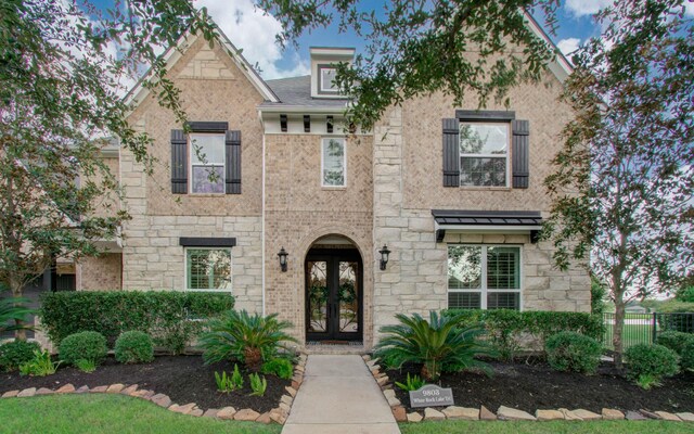 9803 White Rock Lake Trl, Cypress, TX 77433 - view of property featuring french doors and stone siding
