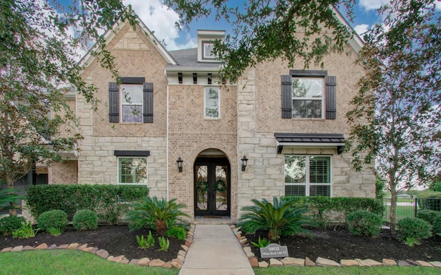 9803 White Rock Lake Trl, Cypress, TX 77433 - view of property featuring french doors and stone siding