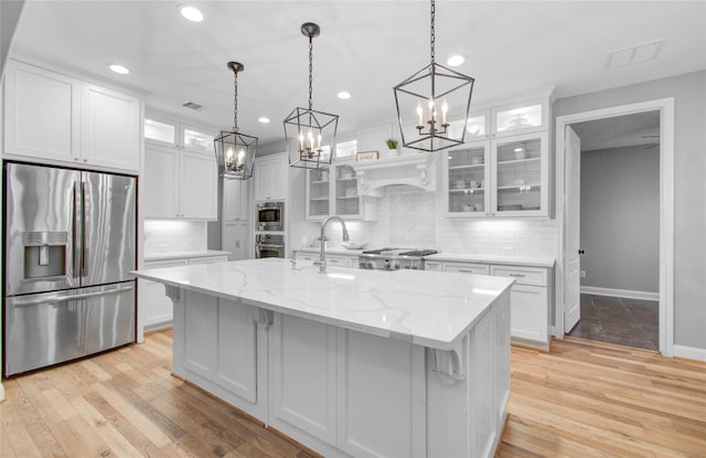 9803 White Rock Lake Trl, Cypress, TX 77433 - kitchen featuring stainless steel appliances, white cabinets, a chandelier, decorative backsplash, and recessed lighting