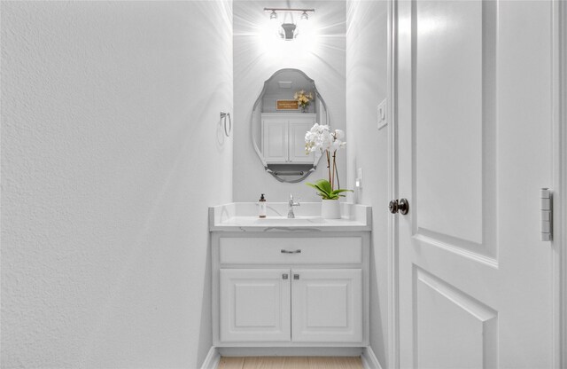 9803 White Rock Lake Trl, Cypress, TX 77433 - bathroom with vanity, a textured wall, and baseboards