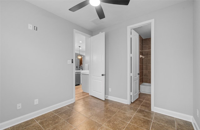 9803 White Rock Lake Trl, Cypress, TX 77433 - unfurnished bedroom with tile patterned floors, ensuite bath, and a ceiling fan