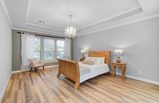 9803 White Rock Lake Trl, Cypress, TX 77433 - bedroom with a raised ceiling, light wood finished floors, a chandelier, and ornamental molding