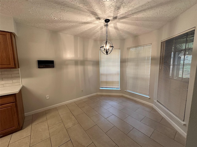 2934 Poplar Creek Ln, Pearland, TX 77584 - unfurnished dining area featuring light tile patterned floors, a chandelier, a textured ceiling, and baseboards