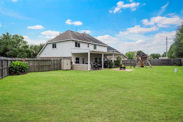 8535 Morning Oak Ln, Cypress, TX 77433 - rear view of property featuring a playground, a patio, a ceiling fan, and a fire pit
