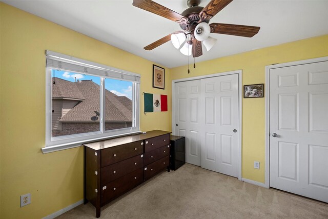 8535 Morning Oak Ln, Cypress, TX 77433 - unfurnished bedroom with light carpet, a closet, baseboards, and a ceiling fan