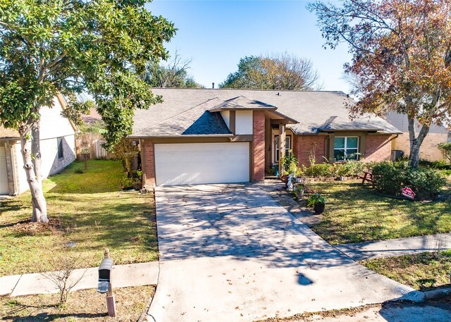 single story home featuring brick siding, an attached garage, concrete driveway, and a front yard