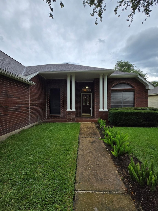 2727 N Larkspur Cir, Pearland, TX 77584 - property entrance with a lawn, brick siding, and a porch