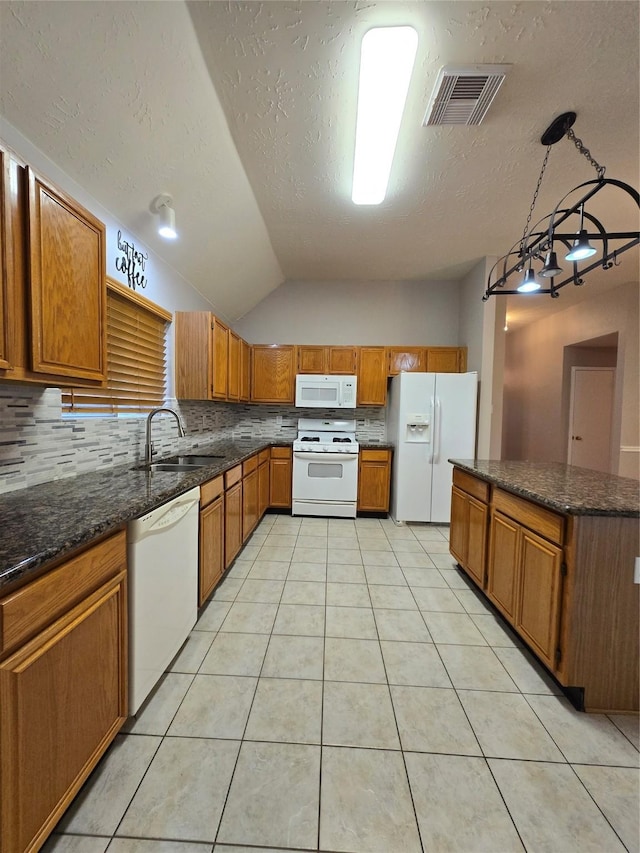 2727 N Larkspur Cir, Pearland, TX 77584 - kitchen featuring white appliances, backsplash, vaulted ceiling, brown cabinetry, and light tile patterned flooring