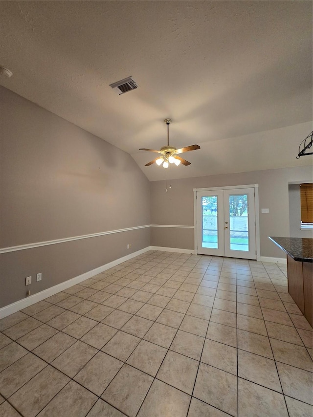 2727 N Larkspur Cir, Pearland, TX 77584 - spare room featuring light tile patterned flooring, french doors, vaulted ceiling, ceiling fan, and a textured ceiling