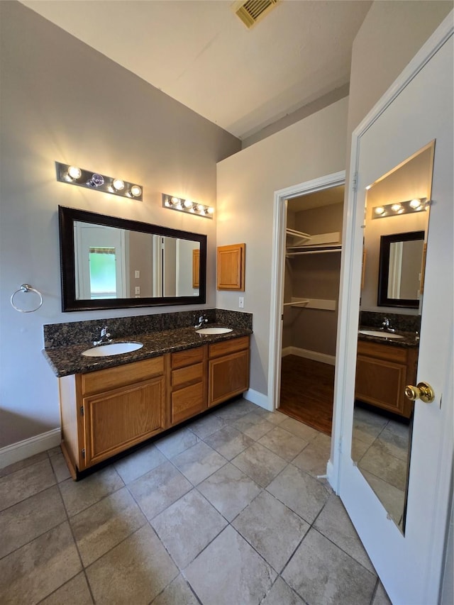 2727 N Larkspur Cir, Pearland, TX 77584 - full bath with double vanity, a spacious closet, and tile patterned flooring