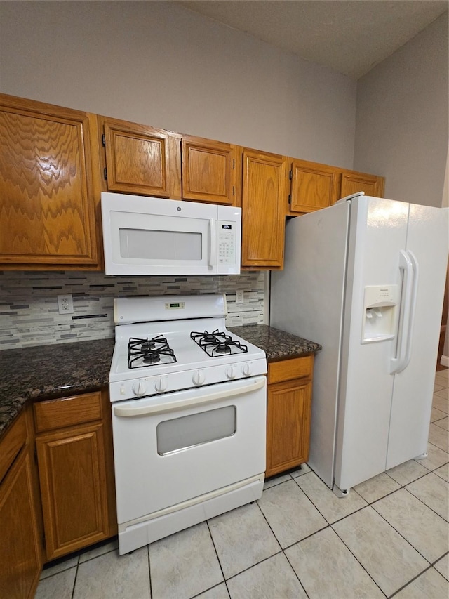2727 N Larkspur Cir, Pearland, TX 77584 - kitchen with white appliances, tasteful backsplash, and brown cabinetry