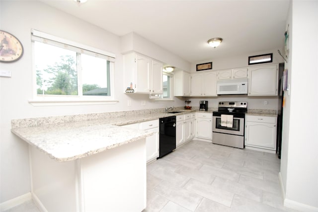 kitchen featuring white microwave, stainless steel electric stove, black dishwasher, a sink, and a peninsula