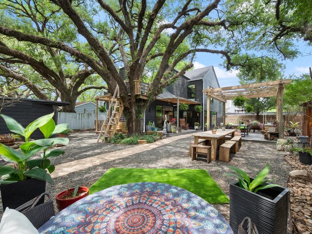 fenced backyard with a pergola, outdoor dining area, a patio area, and stairs