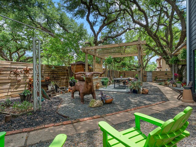fenced backyard featuring a storage shed, a pergola, a patio area, and an outdoor structure