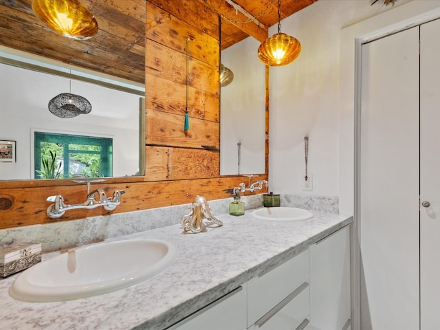 bathroom with double vanity and wooden ceiling