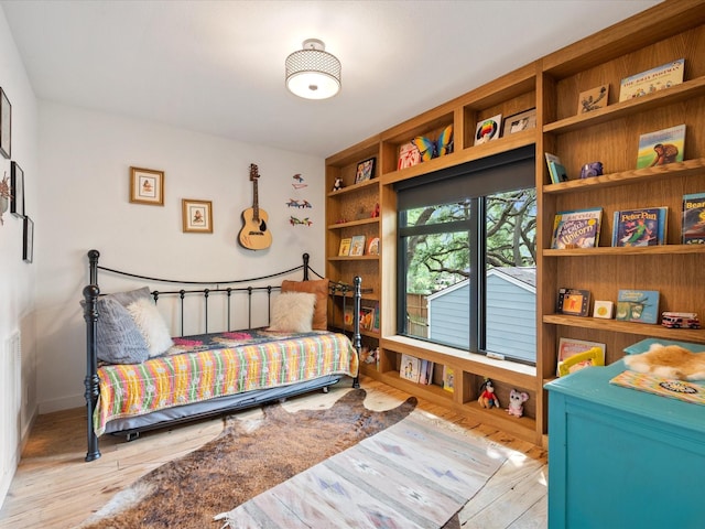 bedroom featuring wood finished floors and baseboards
