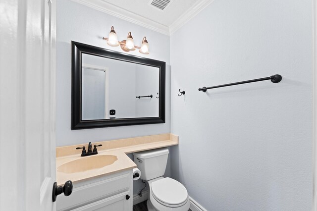 bathroom with crown molding, vanity, and toilet