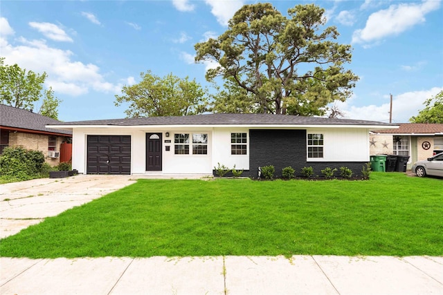 single story home with an attached garage, driveway, and a front yard