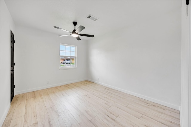 empty room featuring wood finished floors, ceiling fan, and baseboards