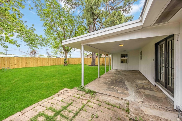 view of yard with a patio area and a carport