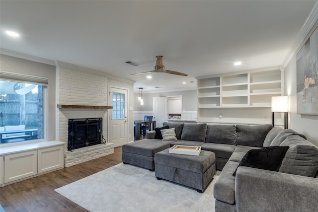 6031 Mcknight St, Houston, TX 77035 - living area with a ceiling fan, ornamental molding, dark wood-style flooring, a fireplace, and recessed lighting