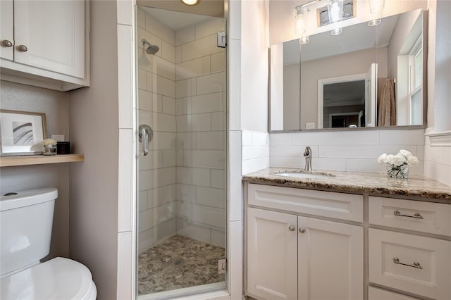6031 Mcknight St, Houston, TX 77035 - bathroom with a stall shower, toilet, vanity, and decorative backsplash