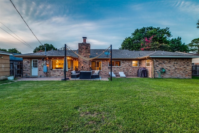 6031 Mcknight St, Houston, TX 77035 - rear view of property with an outdoor living space, a chimney, a patio, and brick siding