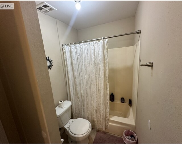 bathroom with toilet and shower / bath combination with curtain