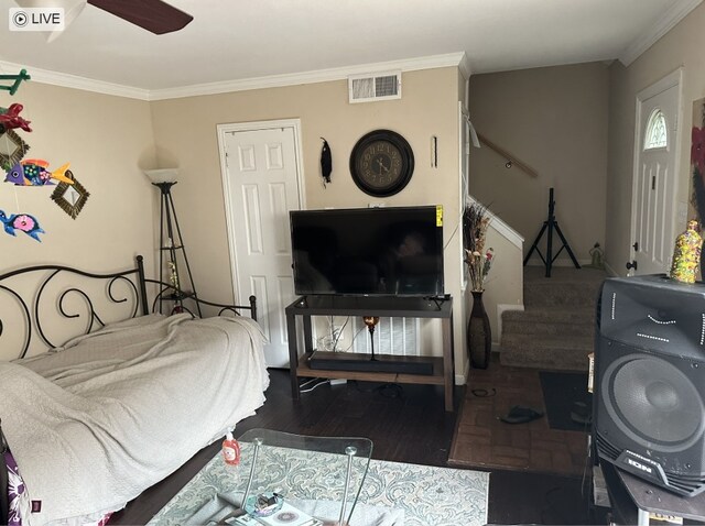bedroom with crown molding, wood finished floors, and a ceiling fan