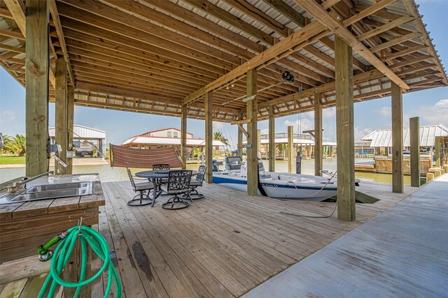 dock area featuring a water view, a sink, and boat lift