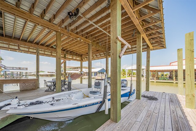 dock with boat lift and a water view