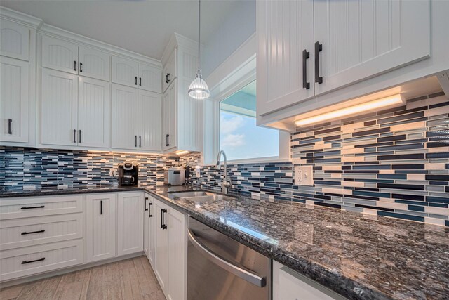 kitchen featuring dishwasher, a sink, backsplash, light wood-style flooring, and white cabinets