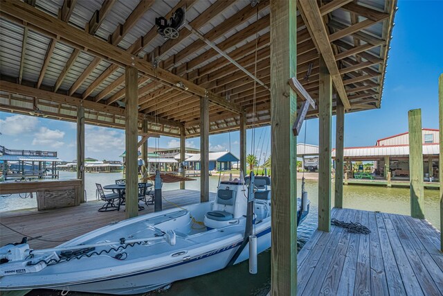dock area with boat lift and a water view