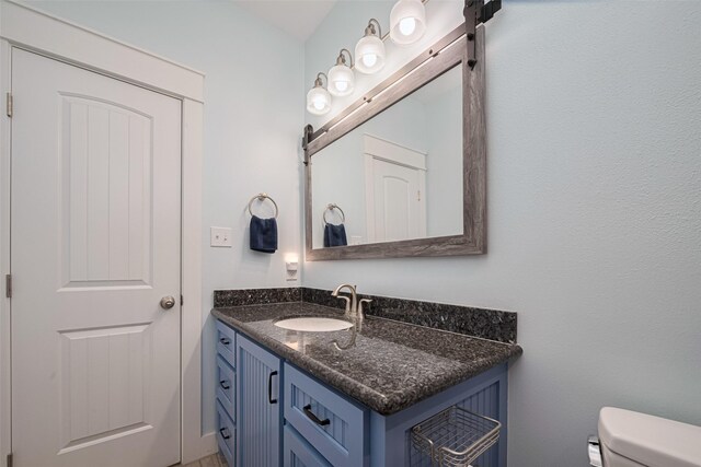 half bath with vanity and toilet
