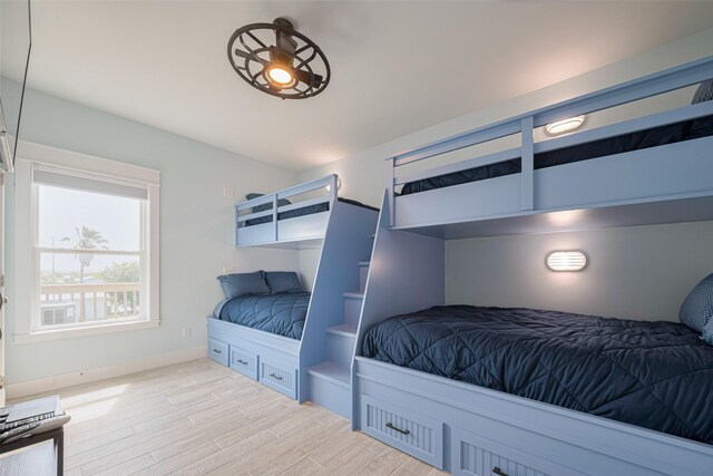 bedroom with light wood-style floors and baseboards