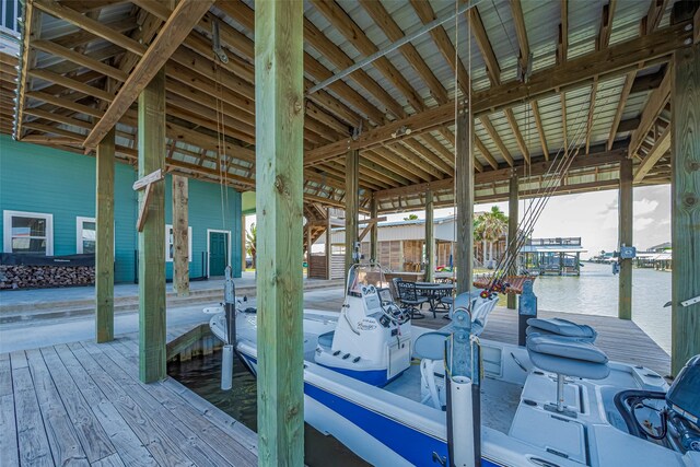 dock area featuring boat lift and a water view