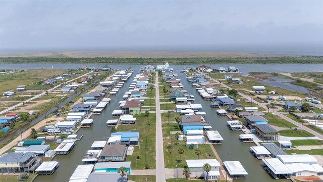 aerial perspective of suburban area with a nearby body of water