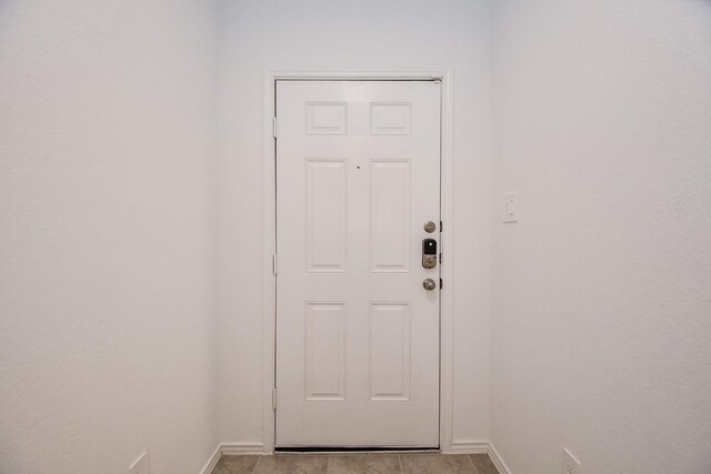 doorway featuring baseboards