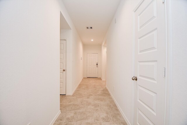 hall with baseboards and recessed lighting