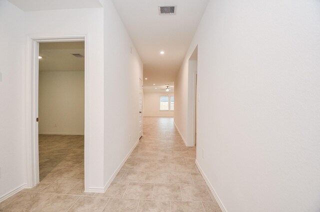 corridor featuring light tile patterned flooring and recessed lighting
