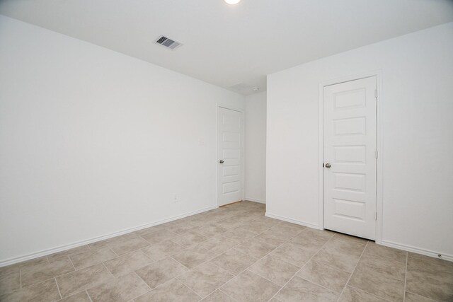 unfurnished room with baseboards